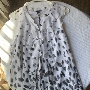 Black and White blouse. 100% polyester. It’s soft frills give a cute but elegant